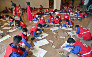 Students participating in Arts & Painting Competition under the theme "Keeping Humanity Alive" in connection with World Red Cross and Red Crescent Week Celebration at Citizen's Club, F-9 Park.