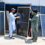 A customer selecting and purchasing solar penal from vendor during summer season at Station Road.