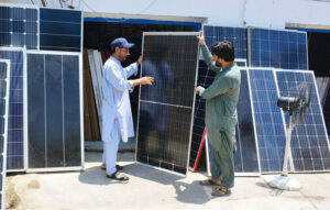 A customer selecting and purchasing solar penal from vendor during summer season at Station Road.