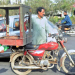 A motorcyclist on the way loaded with room cooler in Provincial Capital.