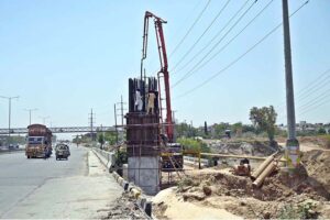 Labourers busy in construction work of flyover at under construction 10th Avenue during development work in Federal Capital.