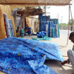 Worker preparing traditional curtain (Chick) at his workplace
