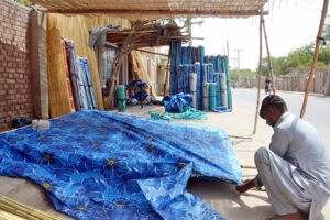 Worker preparing traditional curtain (Chick) at his workplace