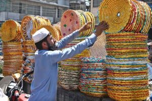 A vendor displaying handmade baskets for packing fruits to attract the customers at Fruit and Vegetable Market.
