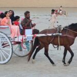 A family enjoying carriage riding at Al manzar picnic point at Indus river area.