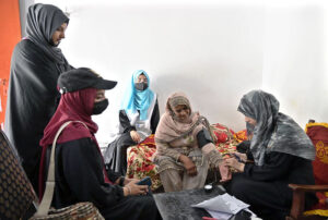 A doctor examining patients during free medical camp organized by NCHD in collaboration with different organization at Dindaar Colony.