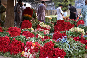 Shopkeepers selecting and purchasing the flowers from wholesale vendors at flowers market.