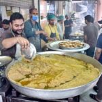 People in a queue to purchase traditional breakfast (Halwa Puri) during morning time