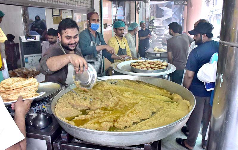 People in a queue to purchase traditional breakfast (Halwa Puri) during morning time