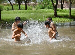 Youngsters bathing in a local stream to get relief from scorching hot weather due to increasing temperature in the Provincial Capital.