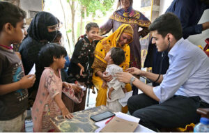 A doctor examining patients during free medical camp organized by NCHD in collaboration with different organization at Dindaar Colony.