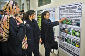 Students taking a keen interest in the poster displayed during a poster competition to celebrate International Day of Biological Diversity organized by the Department of Outreach and Continuing Education Faculty of Social Sciences & Humanities at MNS University of Agriculture.