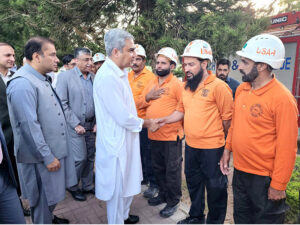 Federal Minister for Interior Mohsin Naqvi shaking hands with the personnel of Emergency Services at CDA Headquarters