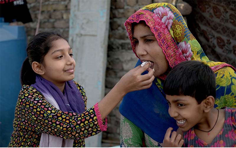 A daughter tenderly feeding cake to her mother and pays tribute to her on Mother's Day, honoring the love and sacrifices that define their cherished bond