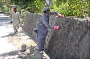 Labourers busy in plaster roadside protective wall as the world celebrates International Labour Day. May 1st, International Workers’ Day, commemorates the historic struggle of working people throughout the world. In 1884, the Federation of Organized Trades and Labour Unions passed a resolution stating that eight hours would constitute a legal day’s work from and after May 1, 1886.