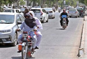 A motorcyclist covered his head and face to protect himself from scorching heat at Club Road.