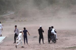 Children playing in a ground as strong duststorm obstruct them at Barakahu.