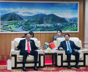 Planning Minister, Ahsan Iqbal and Vice President China Aerospace Science & Technology Corporation, Mr. Lin Yiming discussing their successful joint endeavor to produce a satellite to bolster Pakistan's internet and communication infrastructure.
