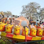 People enjoying mechanized swing at Gulshan-e-Iqbal Park