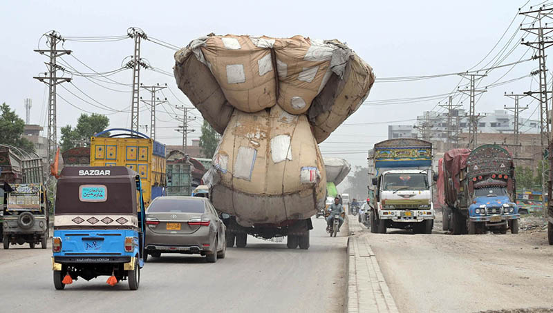 A view of truck heavily loaded with chaff (husk from wheat) on the way at SITE area Road