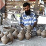 A craftsman busy in preparing the clay-made stuff at his workplace in Kumharpara area.