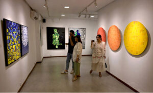 Visitor viewing painting during exhibition “Archipelago of the Self” at Tanzara Gallery.