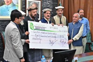 Chief Minister Gilgit-Baltistan, Haji Gulbar Khan giving away cheque of Entry Fees community share of the Khunjrab National Park to the community representative.