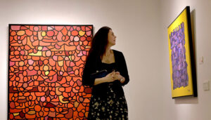 Visitor viewing painting during exhibition “Archipelago of the Self” at Tanzara Gallery.