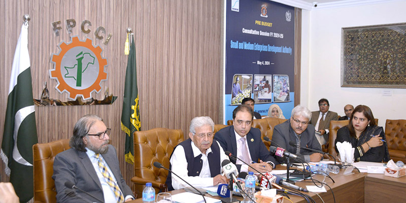 Federal Minister for Industries and Production, Rana Tanveer Hussain addressing meeting at the event of SMEDA