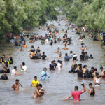 A large number of youngsters bathing in a canal to get relief from scorching hot weather due to increasing temperature in Provincial Capital