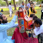 Children enjoying watch traditional film at Shalimar Garden
