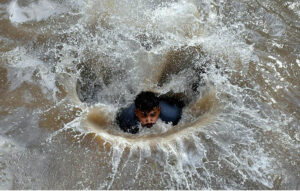 A large number of youngsters bathing in a canal to get relief from scorching hot weather due to increasing temperature in Provincial Capital