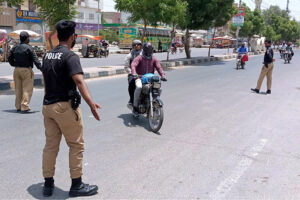 Police personnel checking motorcyclists during snap checking and take strict security in city on the occasion of Youm e Takbeer