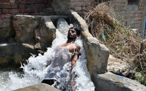 A Youngster bathing in tube well to get some relief from hot weather in the city.