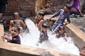 A Youngster bathing in tube well to get some relief from hot weather in the city.