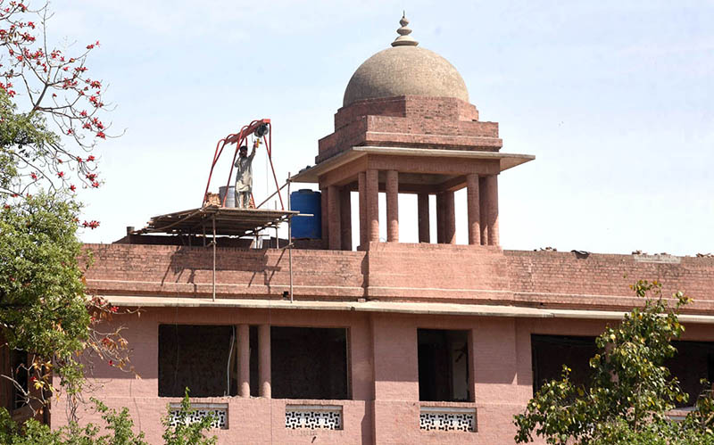 Laborer busy the repair work of Punjab University at Old Campus.