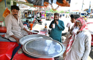 Passengers washing their hands and face at railway station to get relief from hot weather in the city. 