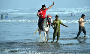 youngster enjoying horse ride as a large number of people arrives at Seaview to get some relief from hot weather in Provincial Capital.
