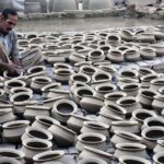 A craftsman preparing clay-made pots at his workplace