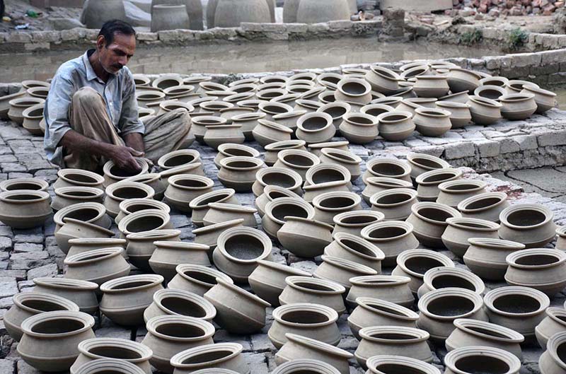 A craftsman preparing clay-made pots at his workplace