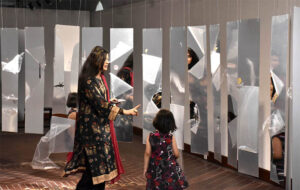 Visitors looking different art work during Exhibition organized by National College of Arts.
