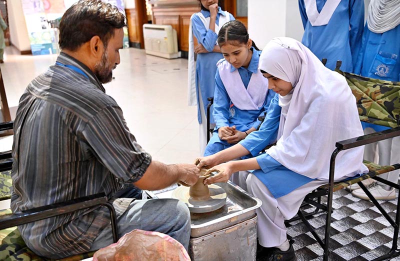 The schoolgirls being taught making of sculpture at SBP Museum on the occasion International Museum Day.