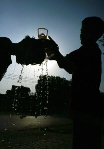 A boy pours water on the head of his fellow one to get relief in the scorching hot day, experiences in the federal capital at G-7 area.