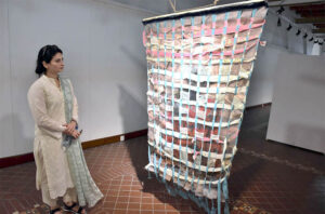 Visitors looking different art work during Exhibition organized by National College of Arts.