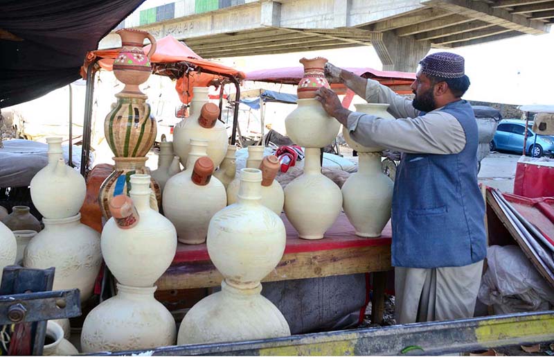 A vendor displaying Matkas at road side in Quetta as it’s common in summer to keep water cold.