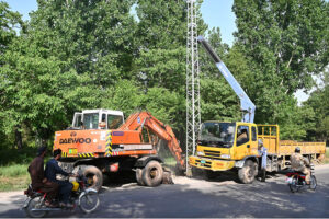 IESCO workers replacing the electric supply line pole during the construction work of Park Road.