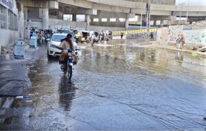 People passing from a road full of sewage water at Sariab Road rejecting the claims of Quetta Metropolitan Corporation of improving the sanitation facilities.