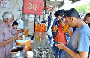 A vendor busy in preparing traditional summer drink for customers at his roadside setup during extreme hot weather in the Provincial Capital.