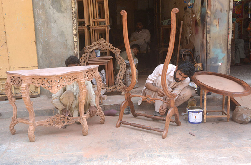 Carpenters making wooden furniture at their workplace