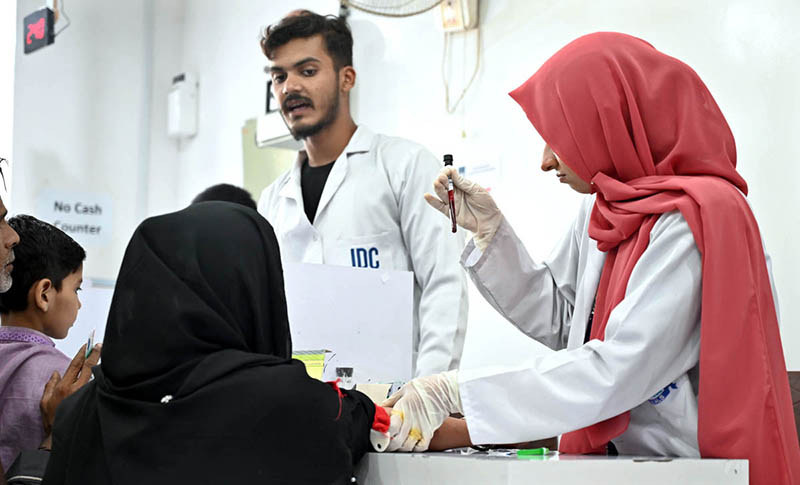 Staff taking blood sample for test at JDC Foundation Pakistan’s Free Diagnostic Lab at M.A. Jinnah Road.